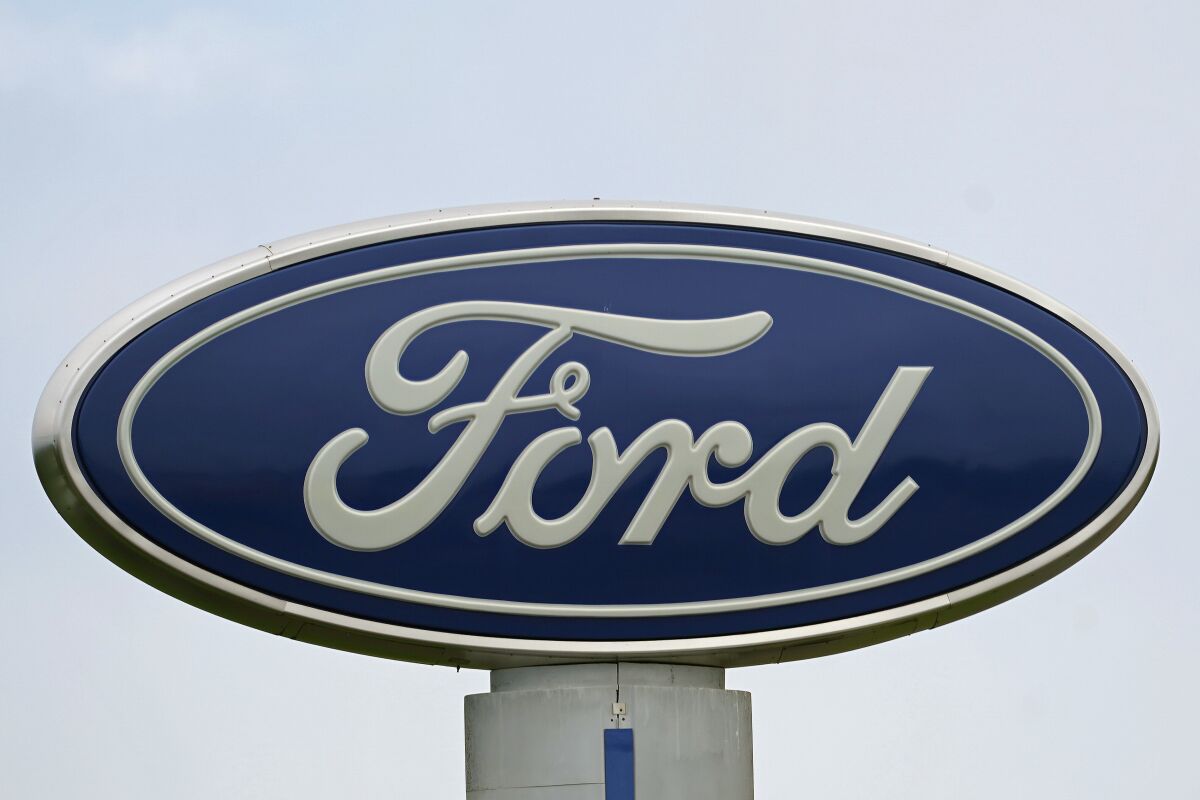 FILE - A Ford logo is seen on signage at Country Ford in Graham, N.C., Tuesday, July 27, 2021. Ford is issuing two recalls covering over 737,000 vehicles, Friday, April 1, 2022, to fix oil leaks and trailer braking systems that won't work. Ford says in government documents posted Thursday, May 19, 2022, is asking the owners of 350,000 vehicles in to take them to dealers for repairs in three recalls, including about 39,000 that should be parked outdoors because the engines can catch fire. (AP Photo/Gerry Broome, File)