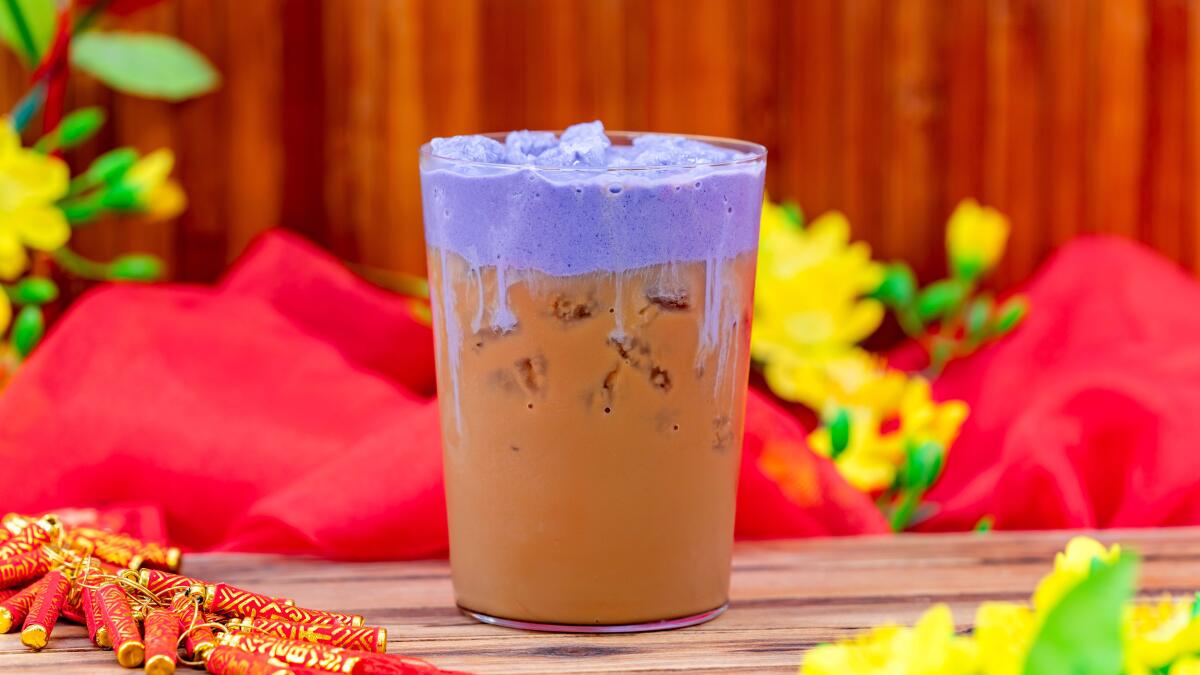 Colorful iced coffee garnished with cocoa powder.