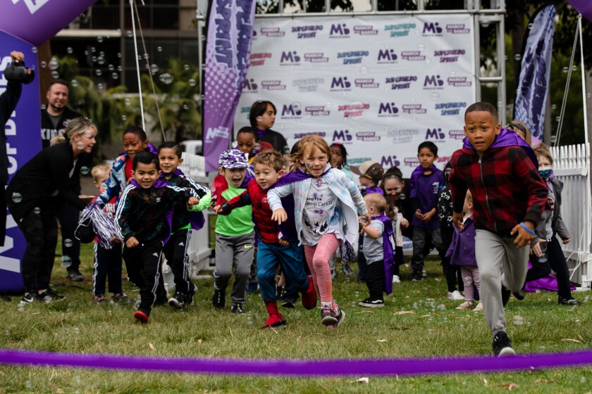 Children run in the Superhero Sprint during the March for Babies 