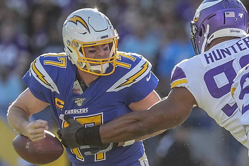 CARSON, CA, SUNDAY, DECEMBER 15, 2019 - Minnesota Vikings defensive end Danielle Hunter (99) strips the ball from Los Angeles Chargers quarterback Philip Rivers (17) then picks it up and runs in for a touchdown late in the second quarter at Dignity Health Sports Park. (Robert Gauthier/Los Angeles Times)