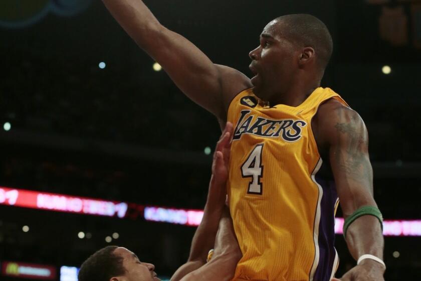 Lakers forward Antawn Jamison is fouled by New Orleans Hornets guard Terrel Harris as he drives to the basket.