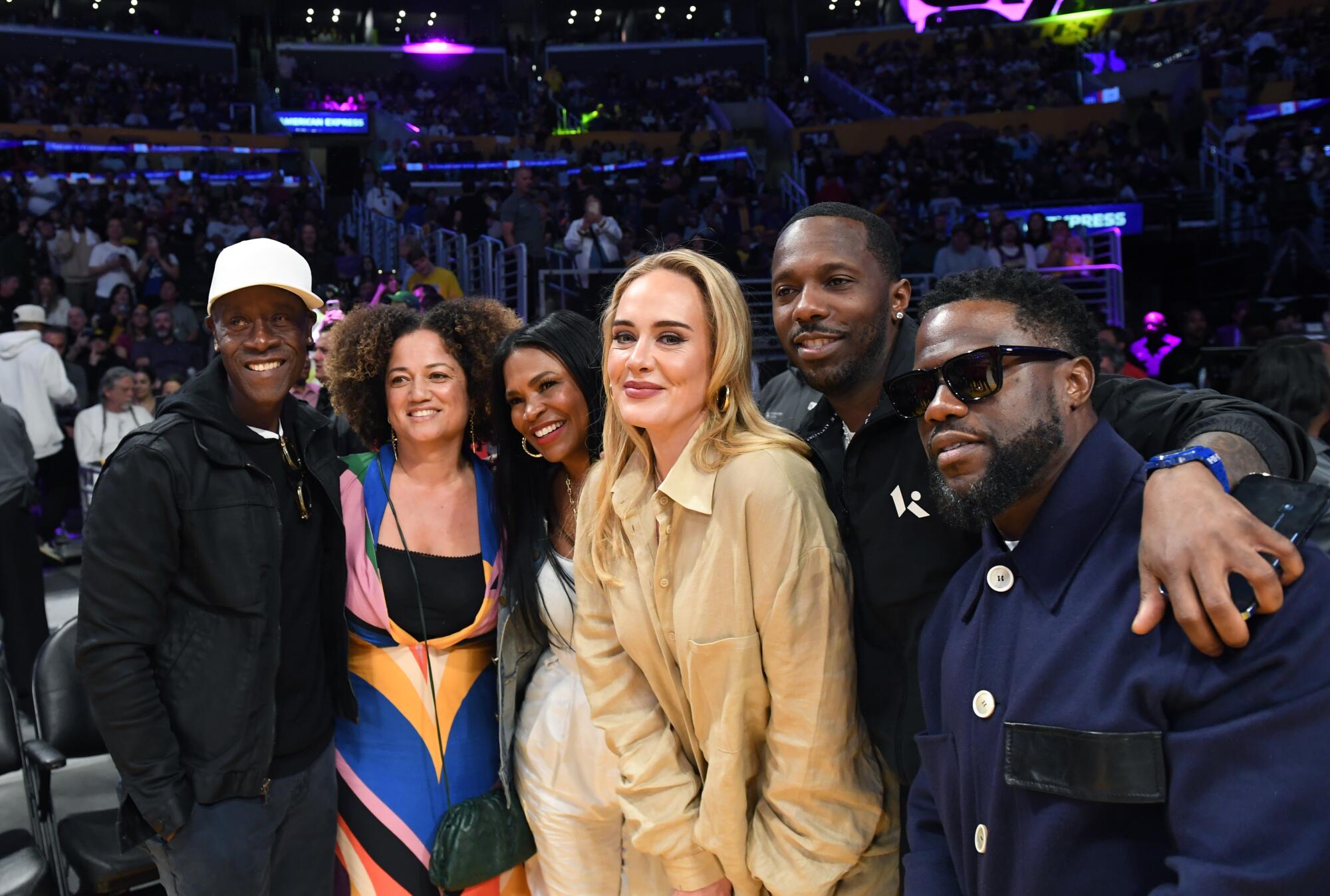 Don Cheadle, from left, stands on the sidelines with his wife and other celebrities during Game 3.