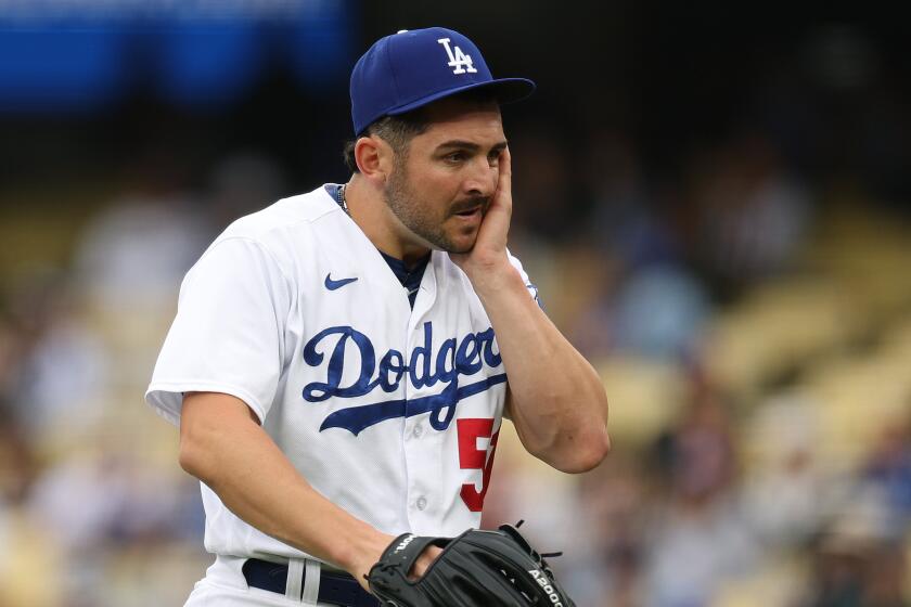 LOS ANGELES, CALIFORNIA - MAY 31: Alex Vesia #51 of the Los Angeles Dodgers reacts as he walks back to the dugout.
