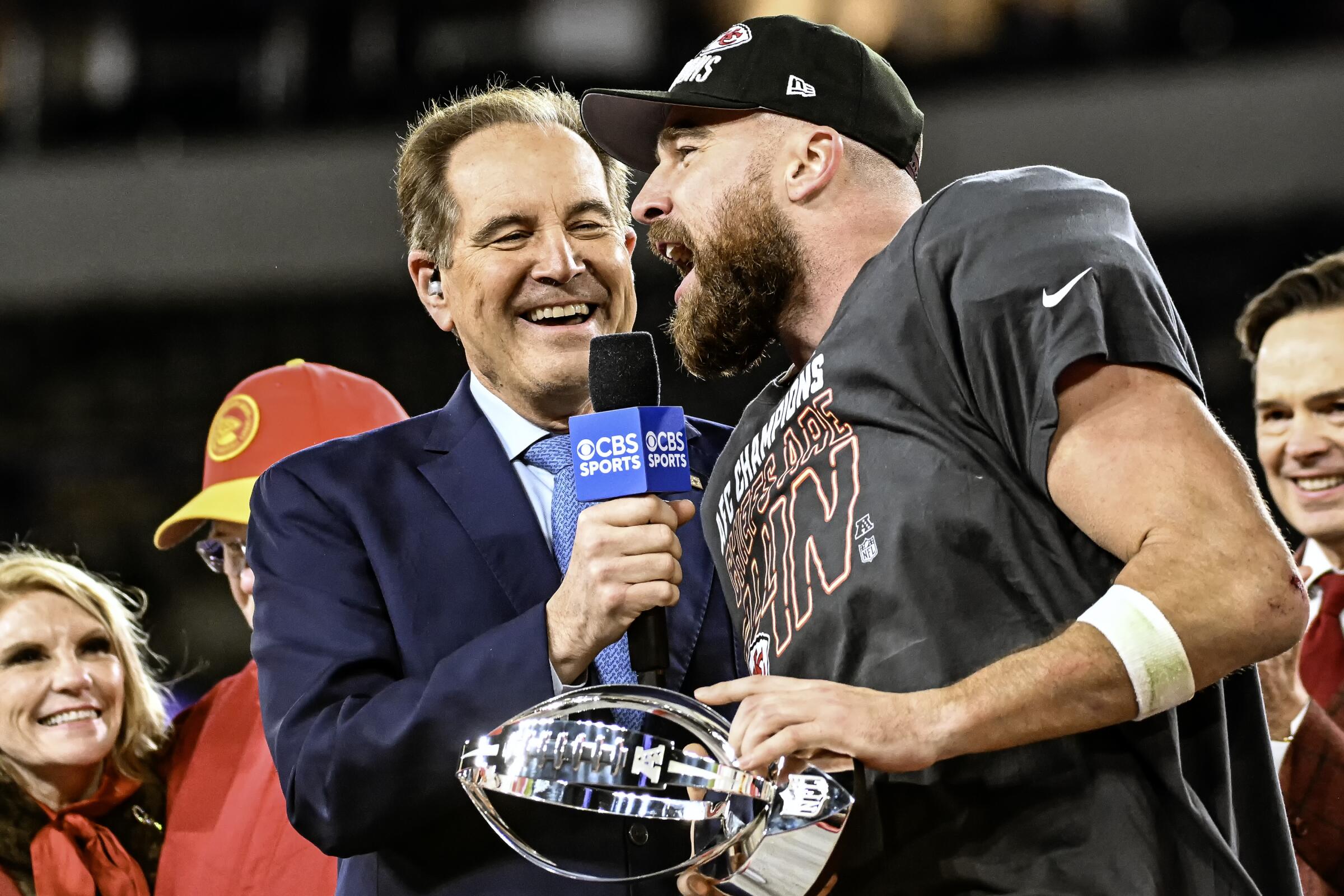 CBS broadcaster Jim Nantz shares a moment on stage with Kansas City tight end Travis Kelce.
