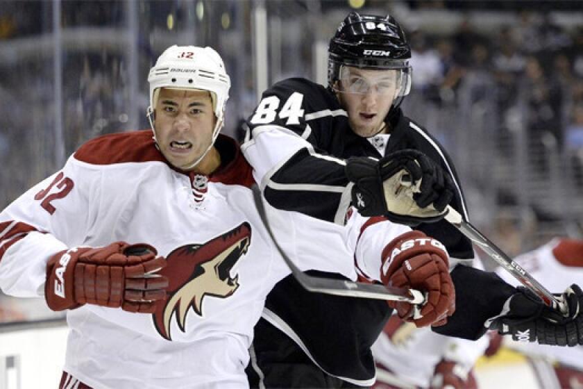 Coyotes right wing Brandon Yip battles with Kings defenseman Derek Forbort during a split squad meeting of the two clubs at Staples Center on Sunday.