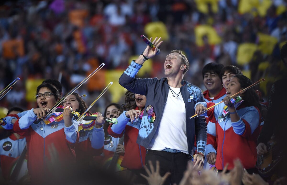 Members of the Youth Orchestra Los Angeles share the stage with Chris Martin of Coldplay at the Pepsi Super Bowl 50 Halftime Show.