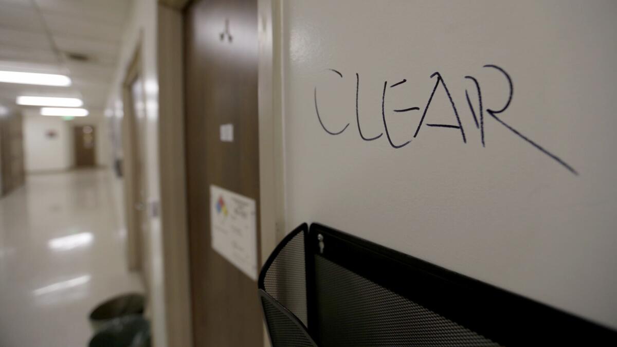 The word "clear" written on a wall near smashed doors on the fourth floor of the Engineering Building at the University of California at Los Angeles.