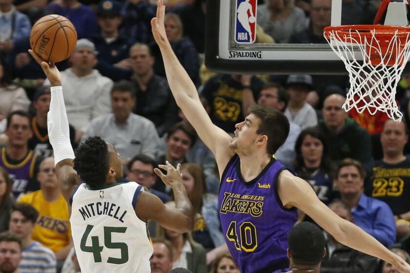Utah Jazz guard Donovan Mitchell (45) shoots as Los Angeles Lakers center Ivica Zubac (40) defends during the first half of an NBA basketball game Friday, Jan. 11, 2019, in Salt Lake City. (AP Photo/Rick Bowmer)