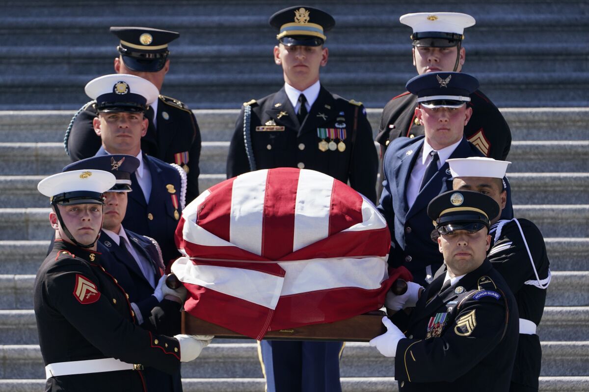 A joint forces honor guard carries the casket of Rep. Don Young, R-Alaska, down the steps of the House of Representatives on Capitol Hill in Washington, Tuesday, March 29, 2022. Young, the longest-serving member of Alaska's congressional delegation, died Friday, March 18, 2022. He was 88. (AP Photo/Susan Walsh)