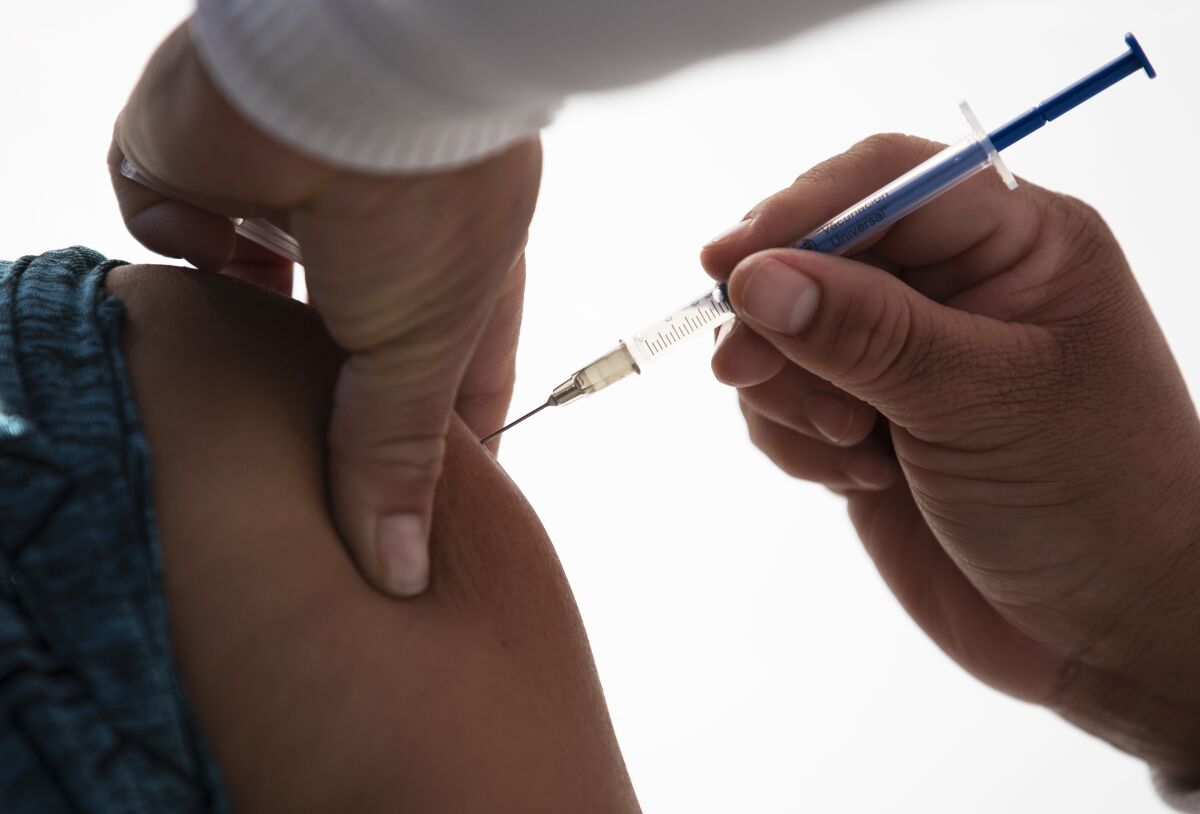 A healthcare worker receives a dose of the COVID-19 vaccine in Mexico City 