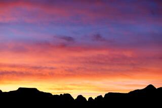 Zion National Park, UT - November 04: The setting suns casts a colorful palette in the skies above Zion Canyon at the end of the Canyon Overlook trail on Saturday, Nov. 4, 2023 in Zion National Park, UT. (Brian van der Brug / Los Angeles Times)