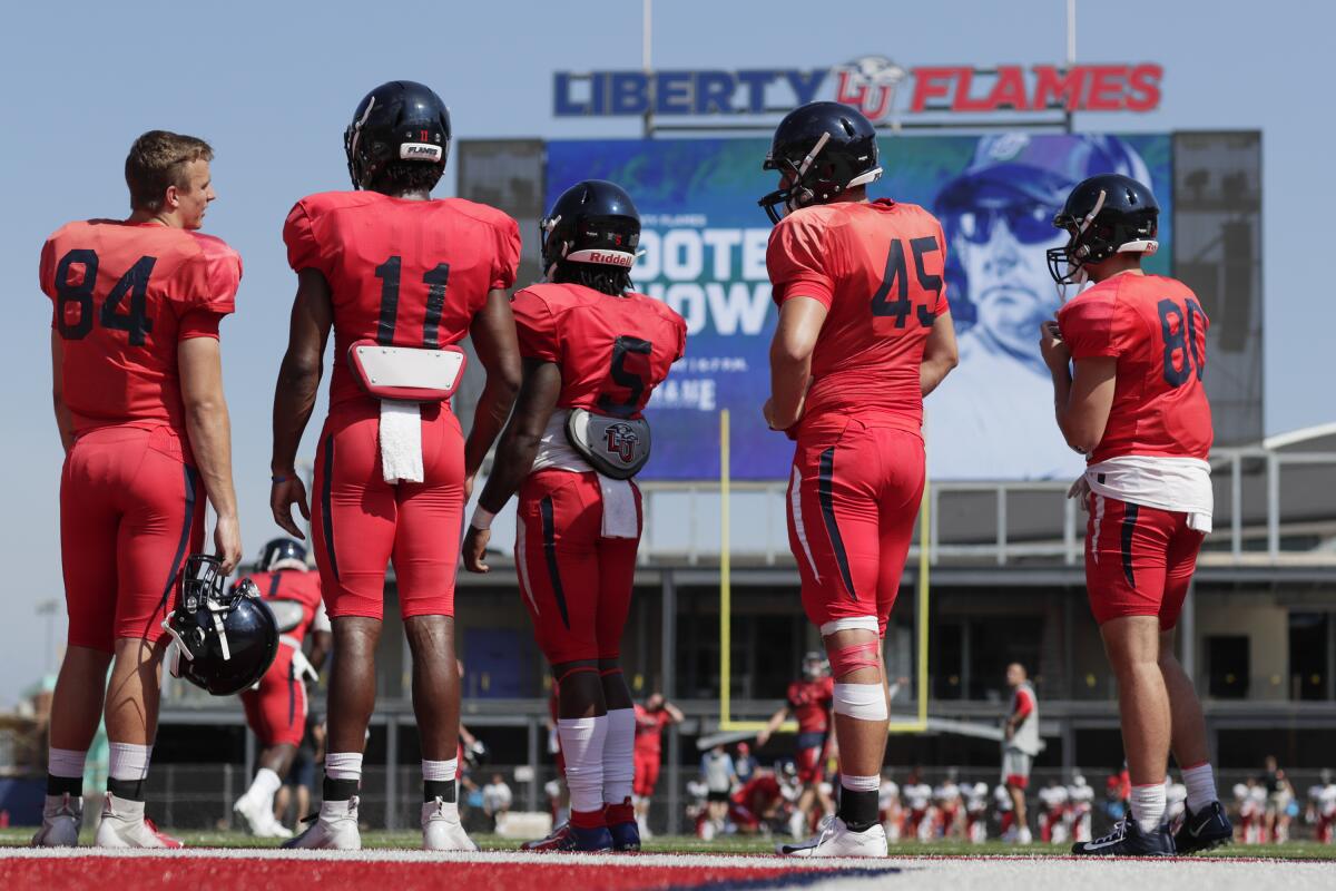 Liberty University football players take the field for an intrasquad scrimmage.