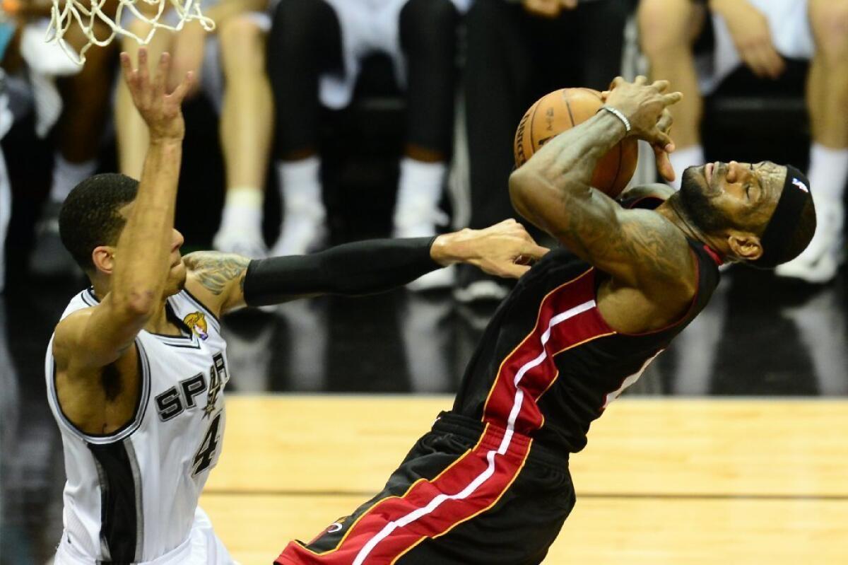 Danny Green stops LeBron James in Game 5 of the NBA Finals between the San Antonio Spurs and the Miami Heat on June 16.