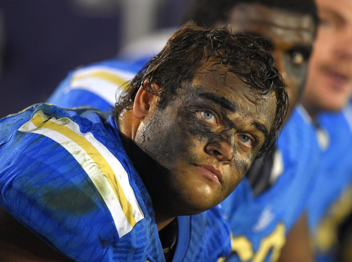 UCLA defensive lineman Eddie Vanderdoes looks on from the bench during the second half of a game against USC on Nov. 22, 2014.