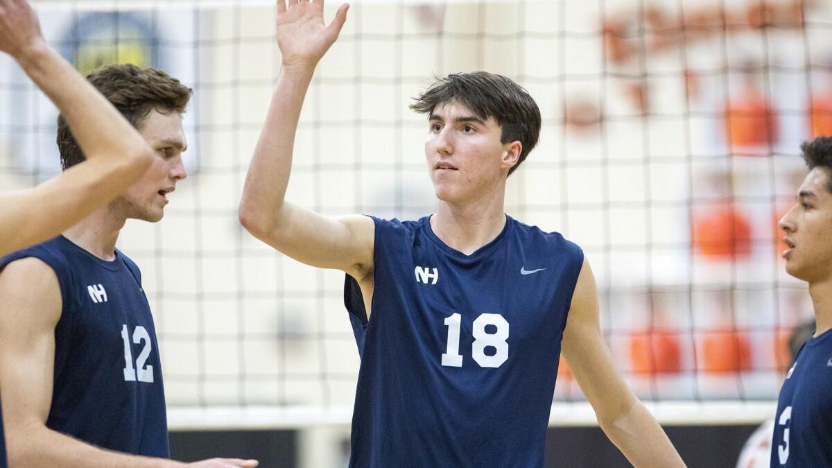 Ethan Talley (18), Dayne Chalmers (12) and Joseph Karlous (3), shown celebrating on March 23, led the Newport Harbor High boys' volleyball team to a sweep of Huntington Beach on Tuesday.