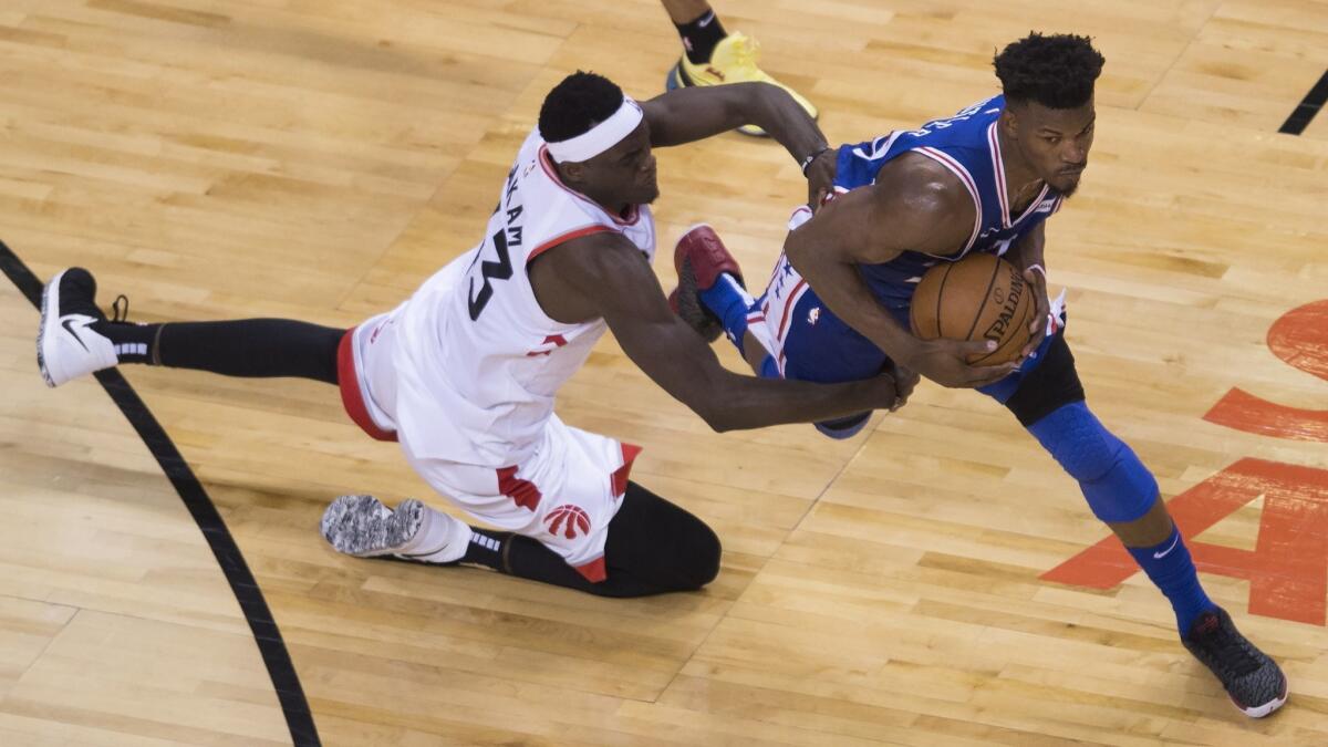 Toronto Raptors forward Pascal Siakam, left, fouls Philadelphia 76ers guard Jimmy Butler during the second half of Game 2 of the NBA Eastern Conference semifinals on April 29.