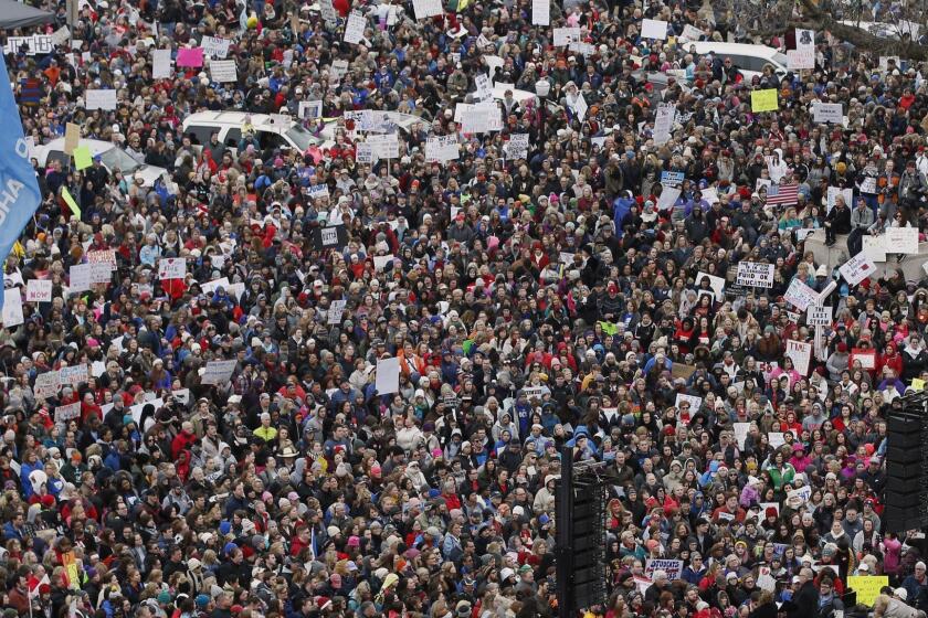 A crowd listens to speakers on a stage, lower right, during a teacher rally to protest low student funding at the state Capitol in Oklahoma City, Monday, April 2, 2018, Teachers were holding separate protests in Oklahoma and Kentucky on Monday to voice dissatisfaction with issues like pay and pensions. (AP Photo/Sue Ogrocki)