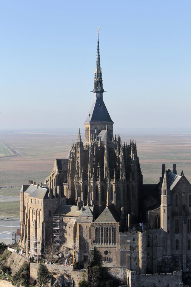 Up until a few years ago, quirky Mont St. Michel, a tidal island (tides vary as much as 50 feet) located off the coast of Normandy, France, was in danger of losing its maritime identity. In the 8th century, a bishop established a small chapel there. A Gothic abbey, used during the French Revolution as a prison, followed a few centuries later. Then in the 19th century a causeway connecting the island to the mainland was built, preventing the sea from washing away silt that collected around the island. A dam that rose in 1969 had a similar effect. Land slowly crept up on the island. Now Mont St. Michel, which receives almost two and a half million visitors a year, is undergoing a face-lift aimed at turning back the accumulated sands of time. More photos...