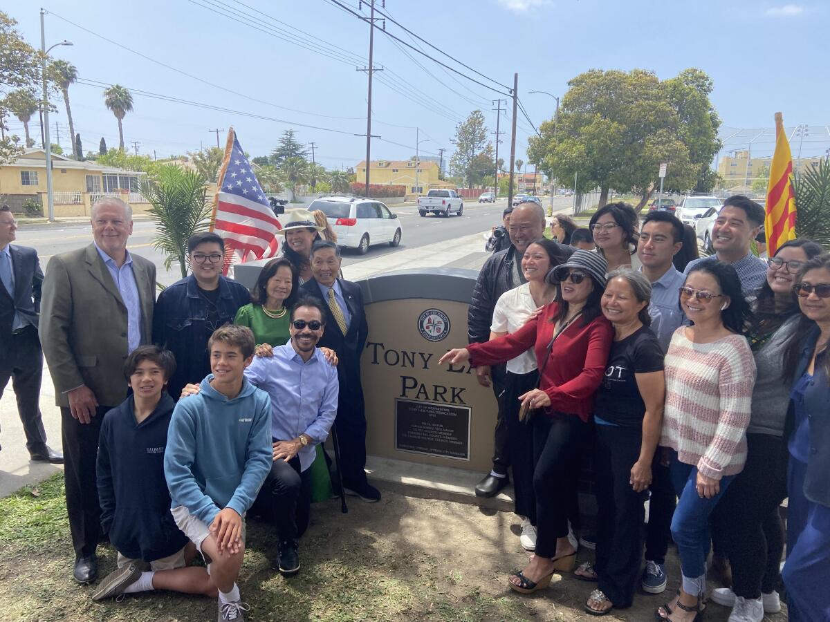 A group of people around a sign that says "Tony Lam Park"