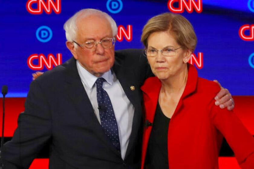 Sens. Bernie Sanders and Elizabeth Warren embrace after Tuesday's debate.