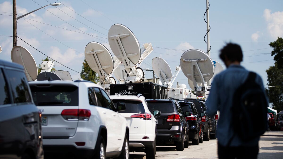 Television news trucks are lined up near the scene of the mass shooting at the Pulse nightclub in Orlando, Fla., on June 13.