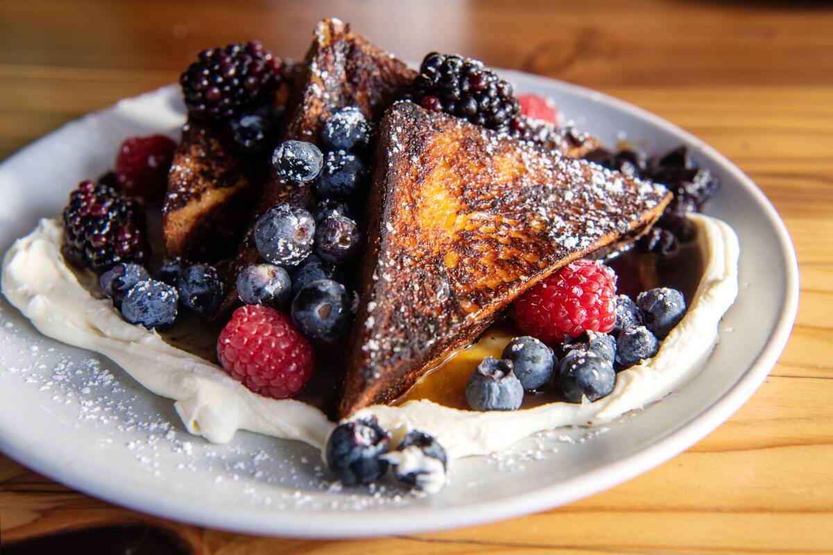 Maple syrup and berry jam sweeten the French toast.