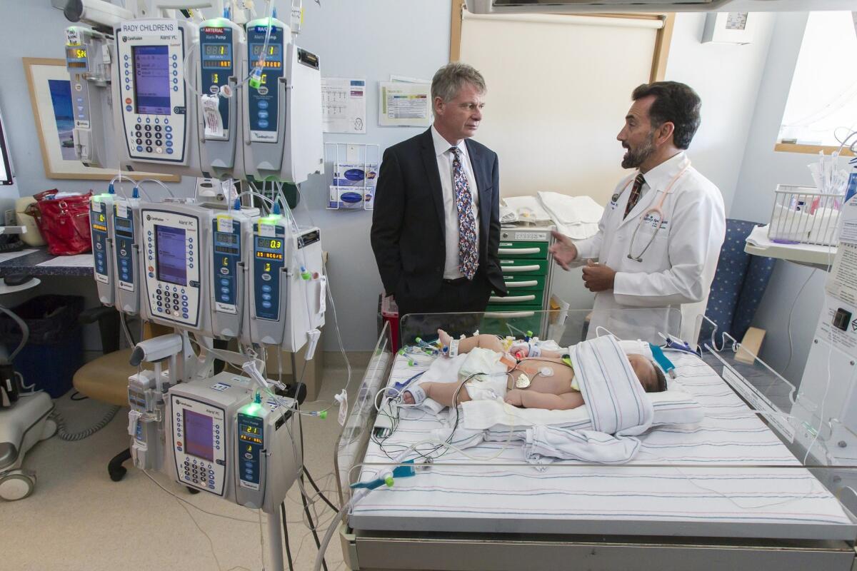 Dr. Stephen Kingsmore (left) speaks with Dr. Mark Speziale Thursday in the neonatal intensive care unit at Rady Children's Hospital Thursday. Speziale is the unit's medical director. — Eduardo Contreras