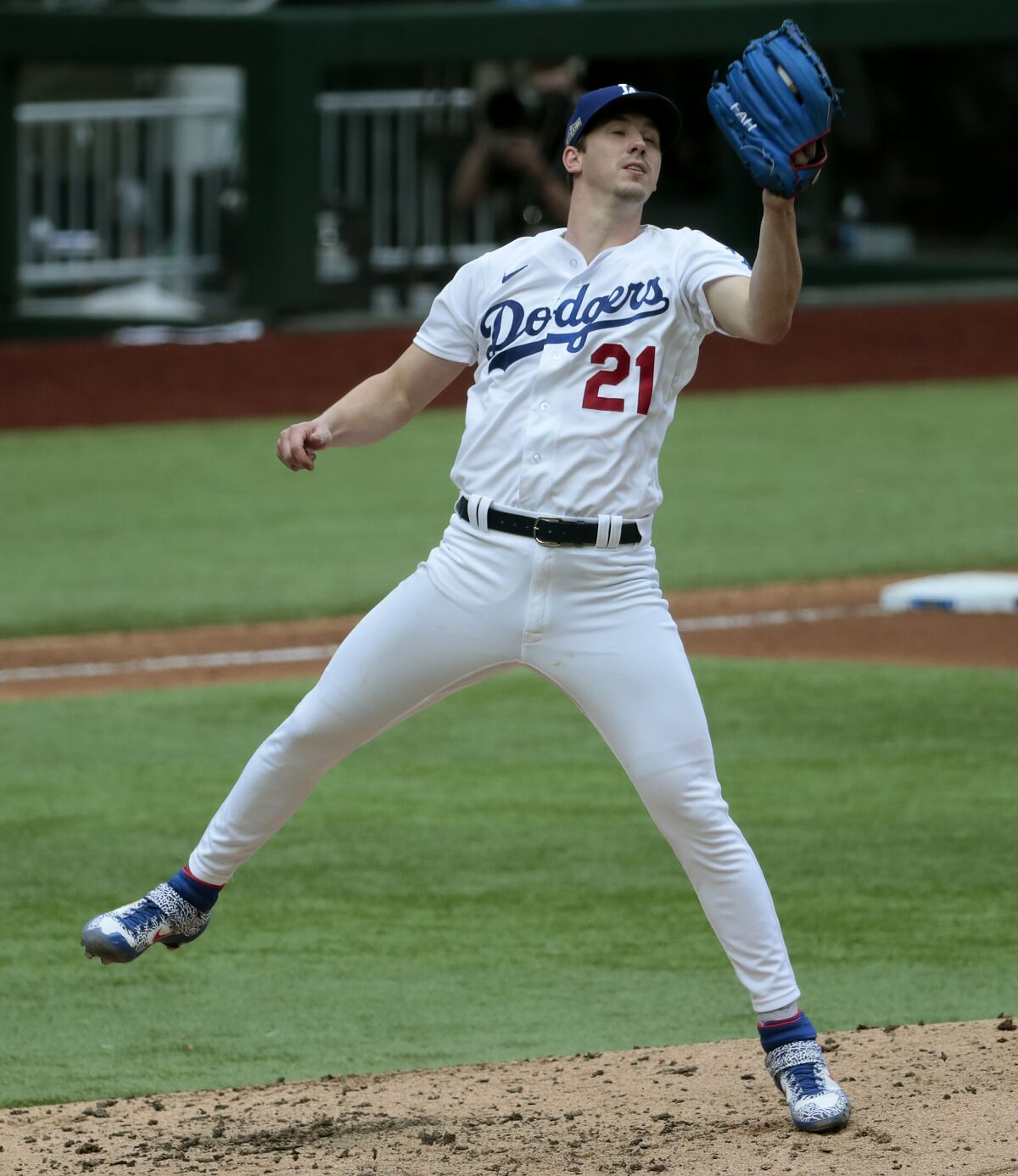 Dodgers starting pitcher Walker Buehler snags a bouncer by Atlanta's Nick Markakis.
