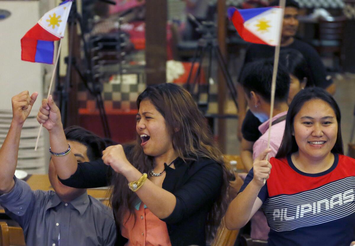In Manila, Filipinos cheer the U.N. international arbitration tribunal's ruling in favor of the Philippines in its dispute with China over the South China Sea on July 12, 2016.