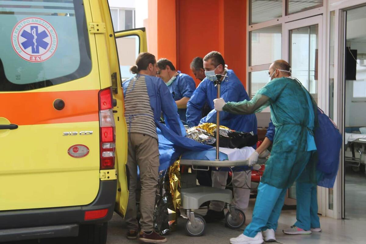 A survivor from a boat full of migrants that sank off the Greek coast is wheeled into an emergency room in the port town of Preveza on Saturday.