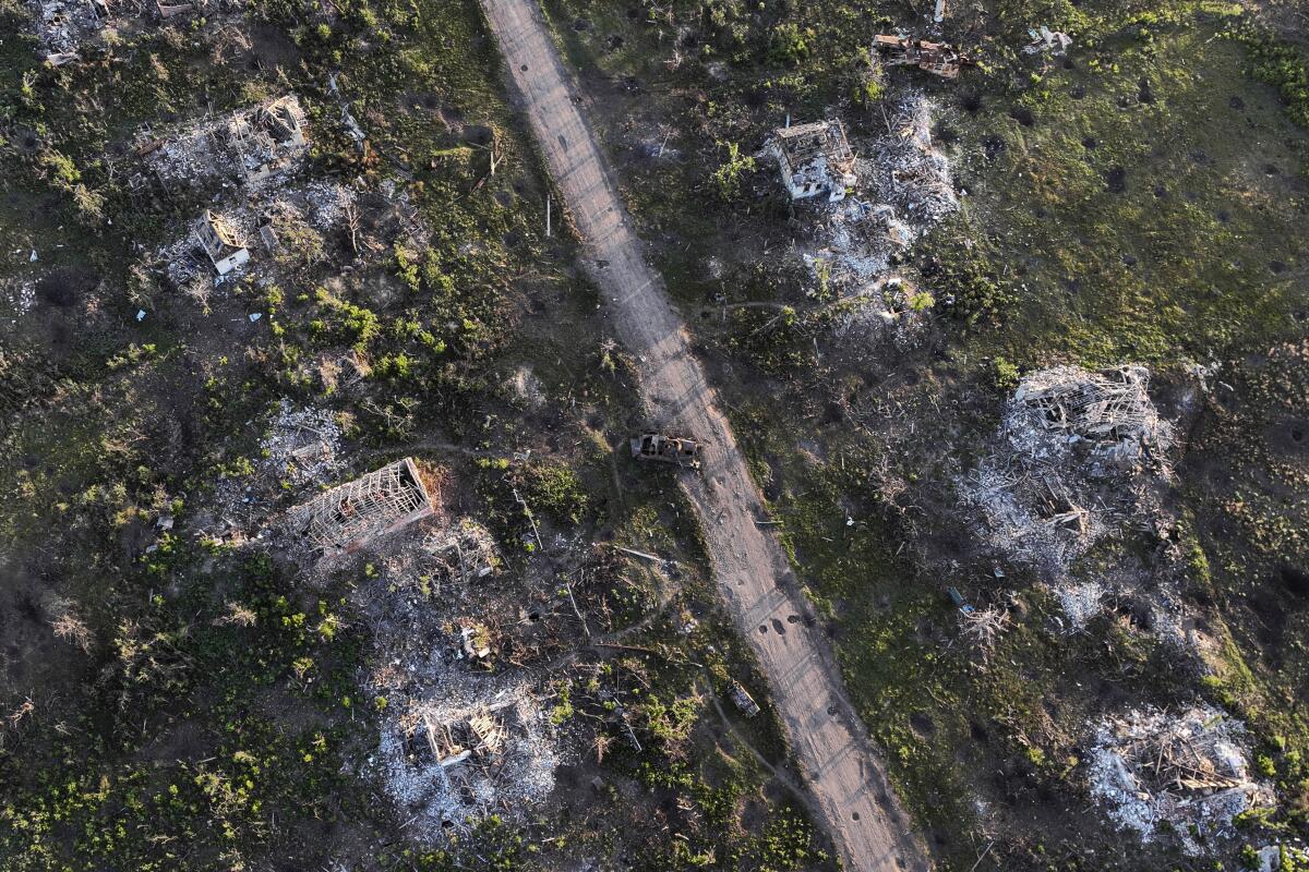 Aerial view of houses and armored vehicles destroyed during fighting in Ukraine