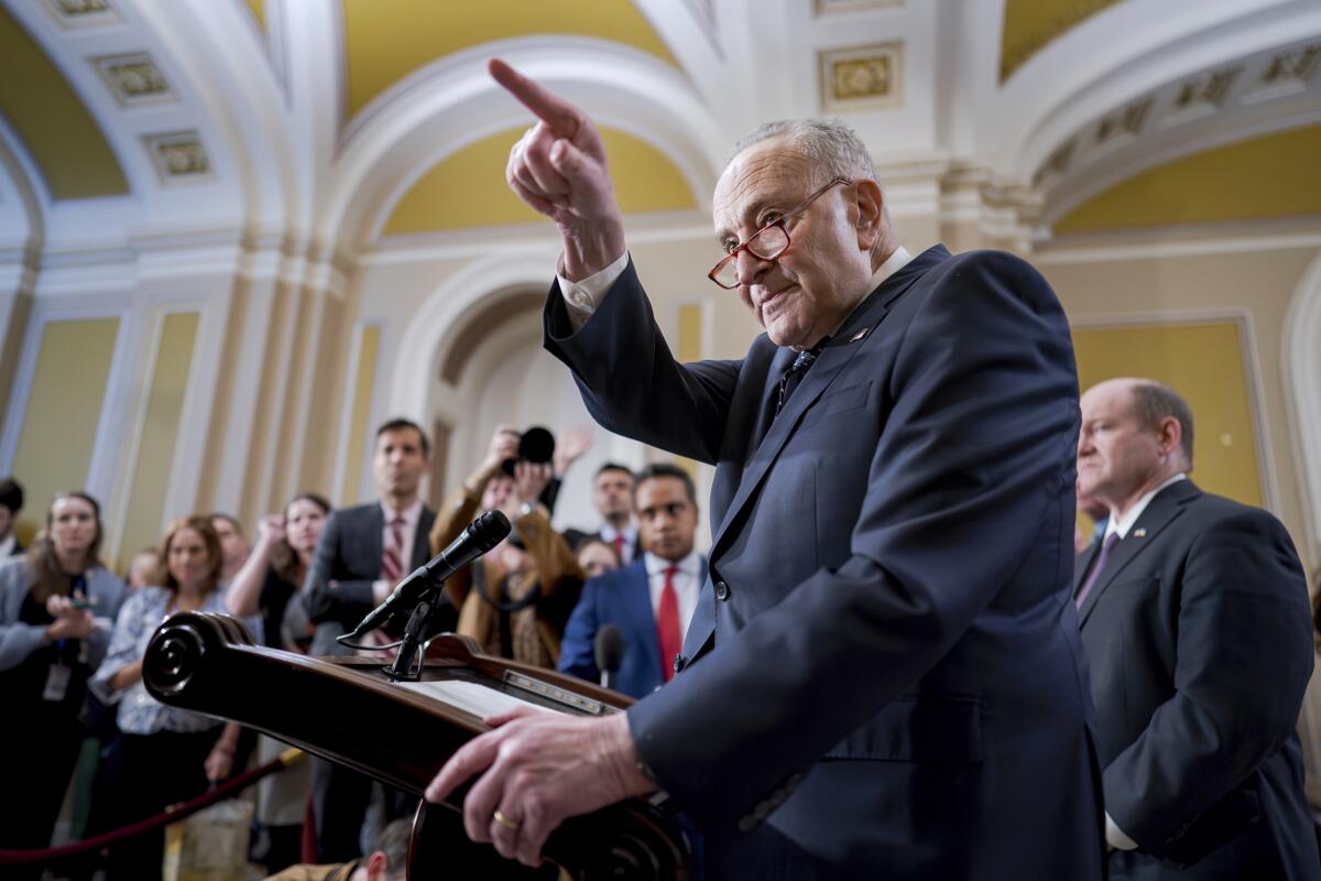 Senate Majority Leader Charles E. Schumer points to a questioner while meeting with reporters in the Capitol