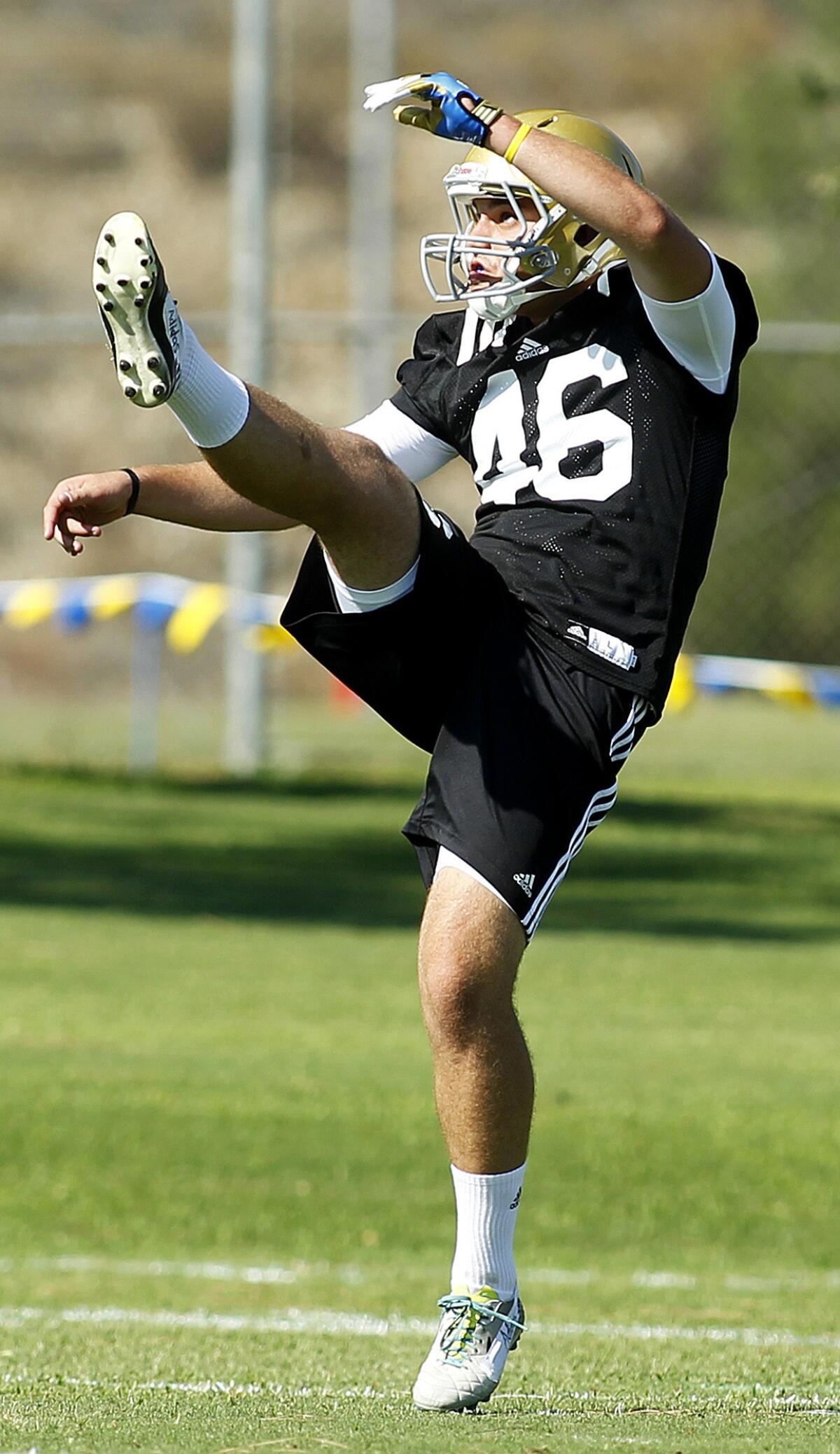 Matt Mengel kicks a ball during an Aug. 4 UCLA football practice at Cal State San Bernardino.