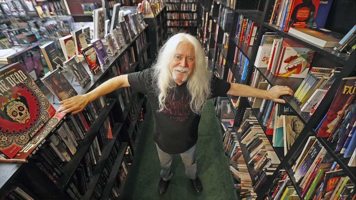 Burbank resident and store owner Del Howison stands inside his horror shop Dark Delicacies in the Magnolia Park area in Burbank on Tuesday.