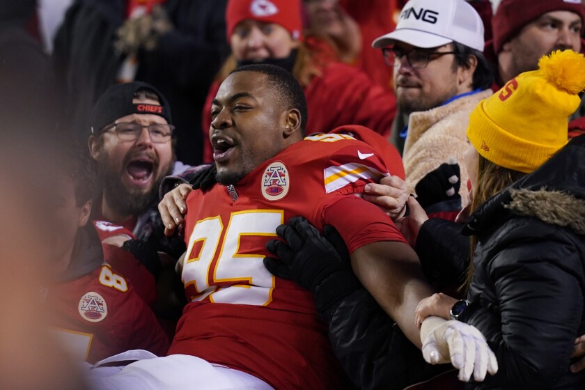 Kansas City Chiefs defensive end Chris Jones (95) celebrates with fans after an NFL divisional round playoff football game against the Buffalo Bills, Sunday, Jan. 23, 2022, in Kansas City, Mo. The Chiefs won 42-36 in overtime (AP Photo/Ed Zurga)
