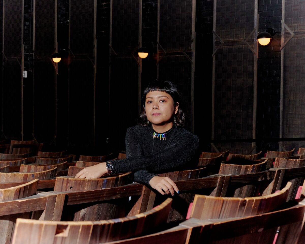 "Leonor Will Never Die" director Martika Ramirez Escobar sits in a theater.