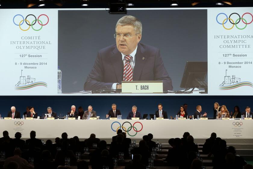 International Olympic Committee President Thomas Bach addresses IOC members in Monaco on Dec. 8.