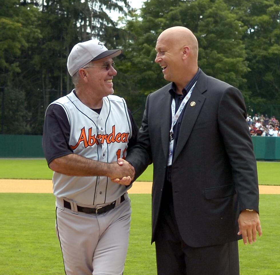 Cal Ripken Jr. gets a handshake from former coach Andy Etchebarren at the beginning of the Aberdeen Ironbirds and the Oneonta Tigers New York-Penn League game held at Doubleday Field in Cooperstown, N.Y.