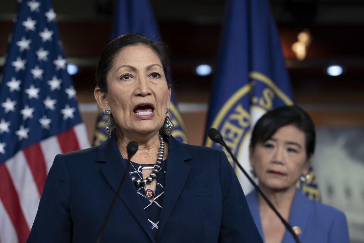 Rep. Deb Haaland speaks into microphones on a lectern