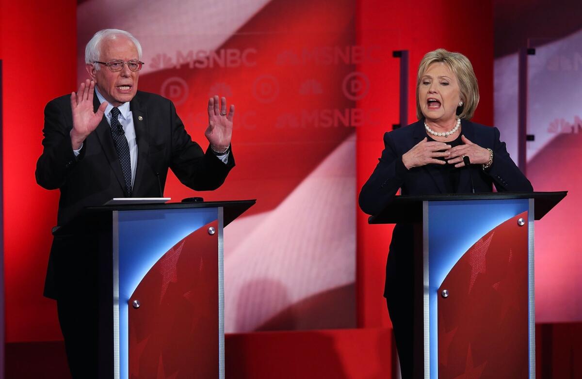 Democratic candidates Hillary Clinton and Bernie Sanders debate in Durham, N.H., on Feb. 4.