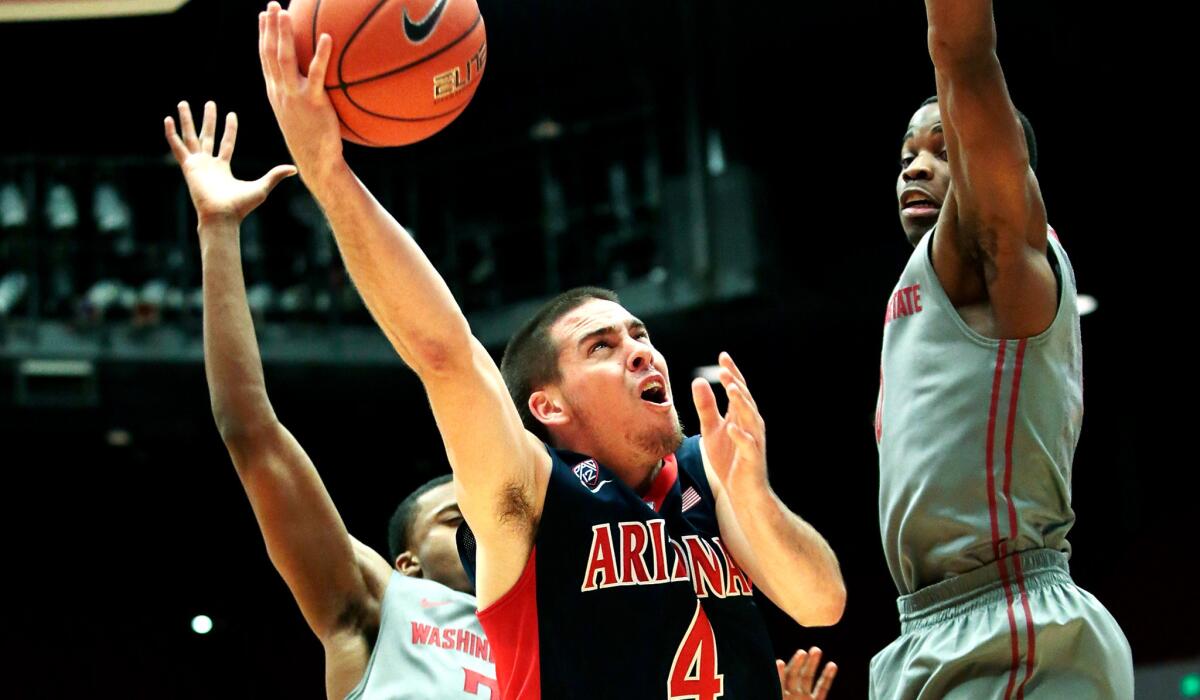 Arizona guard T.J. McConnell tries to score against Washington State's Que Johnson (32) and Ike Iroegbu in the second half Sunday.