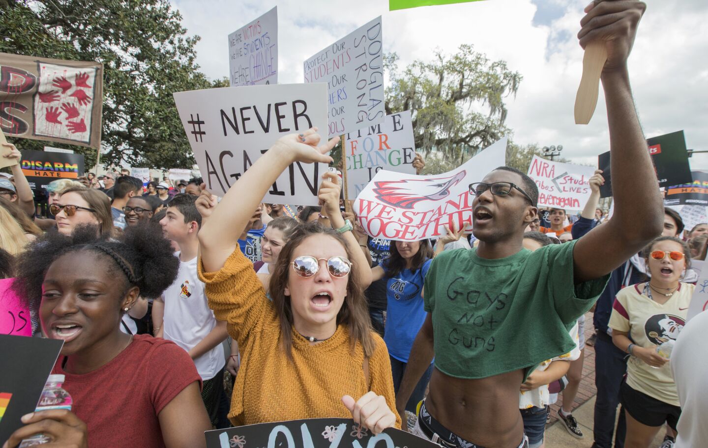 Therese Gachnauer, center, 18, and Kwane Gatlin, right, 19, both high school seniors from Tallahassee, Fla., join fellow students protesting gun violence on the steps of the old Florida Capitol in Tallahassee.