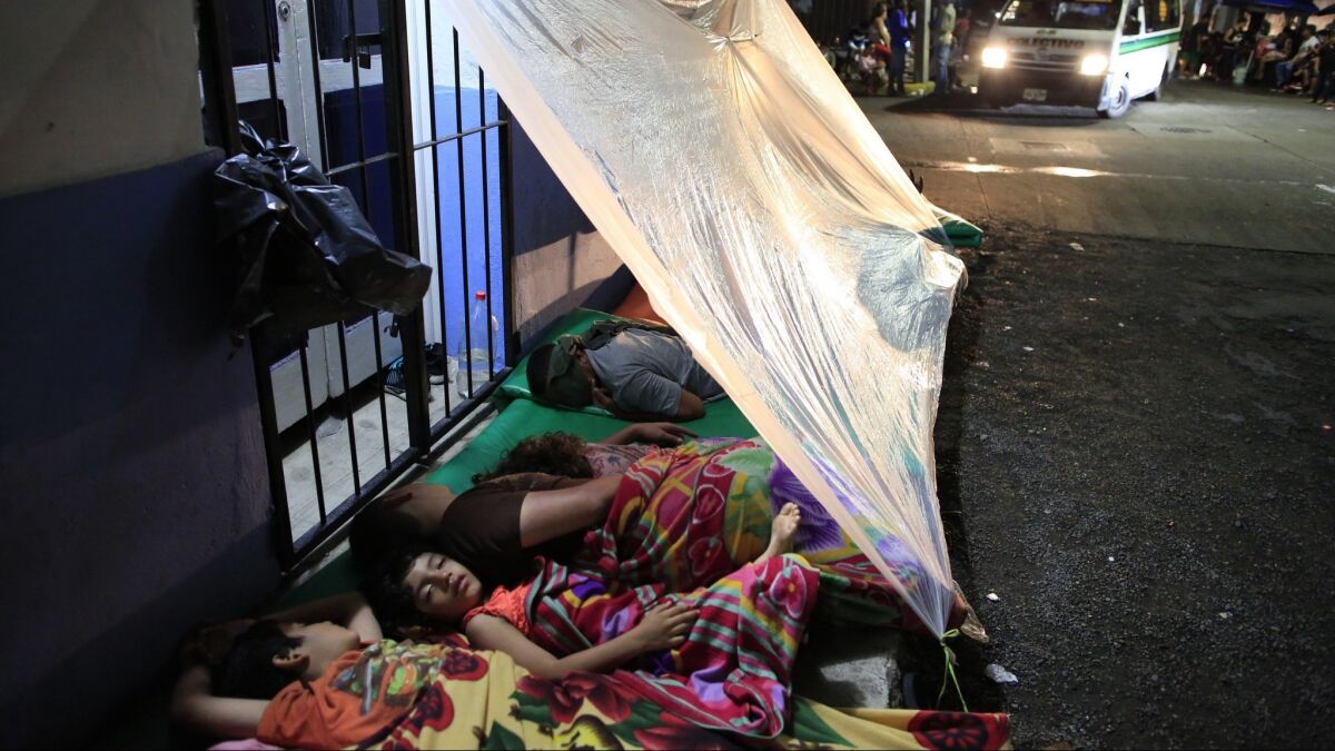 Migrants unable to find shelter sleep in the street outside the offices of the Mexican Commission for Refugee Assistance in Tapachula, Mexico, on June 12, 2019.