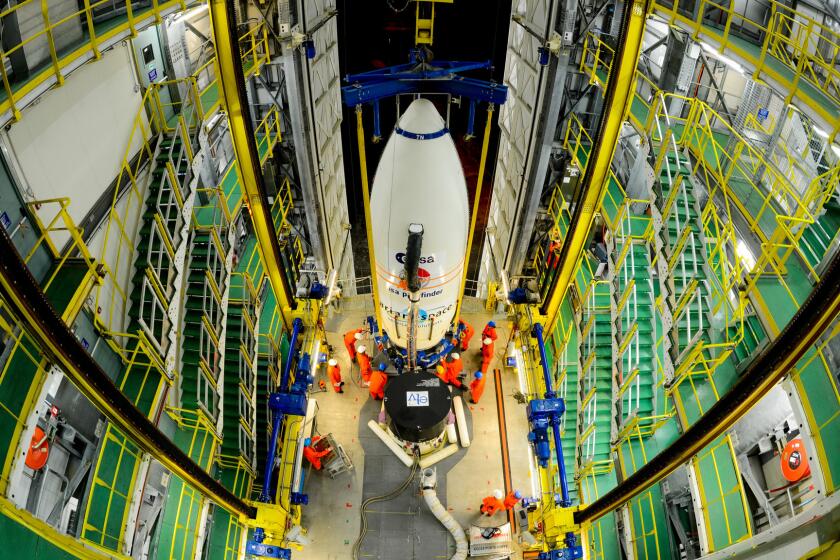 Workers hoist a module carrying the European Space Agency's LISA Pathfinder craft to the top of a rocket. Scientists in the U.K. are concerned about how "Brexit" will affect their work with the ESA and other European science groups.