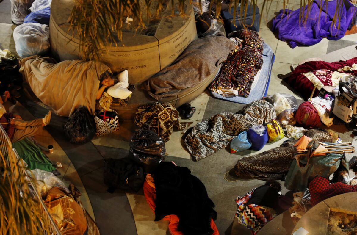 People take refuge from the street and sleep in the entrance of the Midnight Mission in downtown Los Angeles.