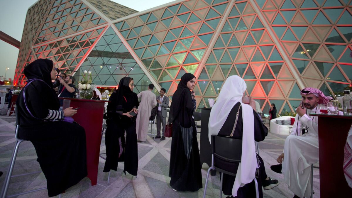 Moviegoers wait to attend an invitation-only screening at the new AMC Cinema in Riyadh.
