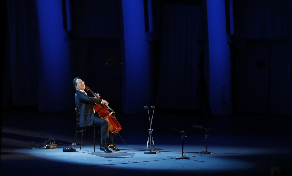 Yo-Yo Ma is shown in a spotlight at the Hollywood Bowl