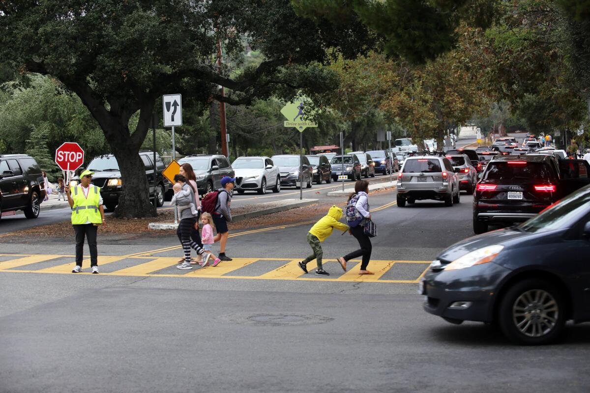 Paradise Canyon Elementary school students use a crosswalk on Knight Way to Paradise Canyon Elementary School. La Cañada Flintridge Public Works staff are working with residents to ease congestion, but the problems are complicated.
