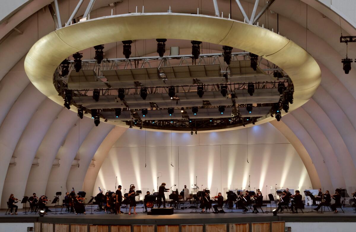 The orchestra onstage in an empty Hollywood Bowl to record for at-home viewing.