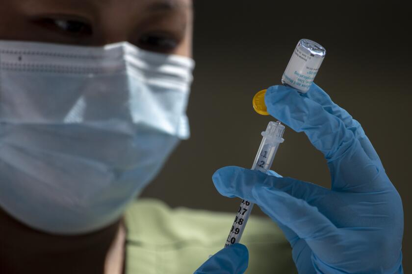 HOLLYWOOD, CA - August 09, 2022- Pharmacist Ngoc-Chau Tran fills syringes with monkeypox vaccine at a new walk-up monkeypox vaccination site at Barnsdall Art Park on Tuesday, Aug. 9, 2022 in Hollywood, CA. (Brian van der Brug / Los Angeles Times)